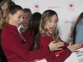 Chloé Dufour-Lapointe, left, and her sister Justine ham it up for the camera after they were introduced to the media in Montreal on Monday January 22, 2018. They will be part of Canada's Olympic freestyle ski team.
