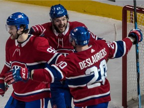 Montreal Canadiens left wing Nicolas Deslauriers (20) is congratulated by teammates left wing Alex Galchenyuk (27) and centre Jonathan Drouin (92) after scoring during 2nd period NHL action at the Bell Centre in Montreal, on Tuesday, Jan. 23, 2018.