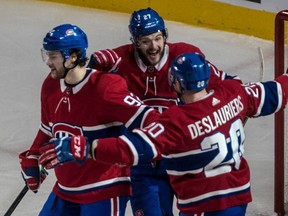 Montreal Canadiens' Nicolas Deslauriers is congratulated by teammates Alex Galchenyuk, centre, and Jonathan Drouin after scoring during second period at the Bell Centre in Montreal, on Tuesday, January 23, 2018.