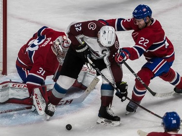 Montreal Canadiens goaltender Carey Price (31) watches the loose puck roll by while teammate defenceman Karl Alzner (22) checks Colorado Avalanche left wing Gabriel Landeskog (92) during 2nd period NHL action at the Bell Centre in Montreal, on Tuesday, Jan. 23, 2018.