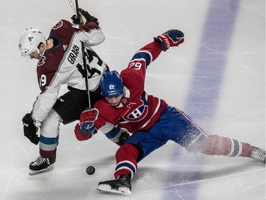 Montreal Canadiens left wing Artturi Lehkonen (62) is knocked to the ice by Colorado Avalanche defenceman Samuel Girard (49) while trying to get the loose puck during 3rd period NHL action at the Bell Centre in Montreal, on Tuesday, Jan. 23, 2018.