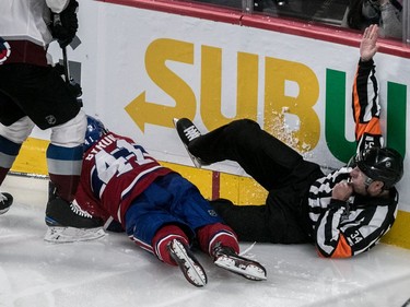 Referee Tom Chmielewski (43) calls the play dead after being accidentally knocked to the ice by Montreal Canadiens left wing Paul Byron (41) during 3rd period NHL action at the Bell Centre in Montreal, on Tuesday, Jan. 23, 2018.