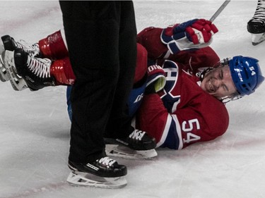 Montreal Canadiens left wing Charles Hudon (54) grimaces in pain after being knocked to the ice against the Colorado Avalanche during 3rd period NHL action at the Bell Centre in Montreal, on Tuesday, Jan. 23, 2018.