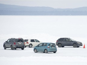 Four cars participate in a winter ice driving lesson on the Lake of Two Mountains.