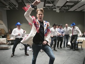 Daniel Okulitch portrays Lyndon Baines Johnson, backed by a squad of political cowpokes, in a rehearsal of a scene from the Opéra de Montréal presentation of JFK. The vice-president seen here is "a parody of the real LBJ, filtered through (Kennedy's) imagination and prejudices,” according to the creators.