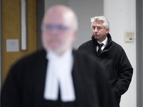 Jimmy Accurso, son of Antoino Accurso, walks behind lawyer Marc Labelle as he leaves the Joliette courthouse after testifying in his father's trial Jan. 26, 2018.
