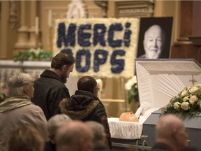 People pay their last respects to Father Emmett Johns known as "Pops" at his funeral at Saint Patrick's Basilica in Montreal on Saturday, Jan. 27, 2018.