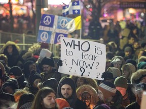 People attend a vigil for victims of the mosque shooting in Quebec City Monday, January 30, 2017 in Montreal.