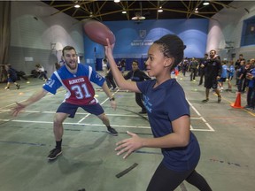 Montreal Alouettes Mikael  Charland plays some football with Dali Tshuma at the Academie Sainte-Anne in Dorval as part of the Ultimate Football Tour Official Launch on Tuesday.