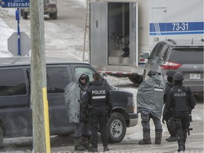 Montreal police surround a home in Pointe-Claire after reports that a man was barricaded inside with a weapon, Jan. 31, 2018.