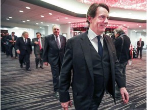 Pierre Karl Peladeau smiles as he walks with other members of the head table at the Montreal Chamber of Commerce luncheon in Montreal on Feb. 22, 2017.