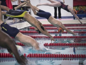 Swimmers jump off the starting-block during a regional meet in Beaconsfield last November. Figuring prominently in Beaconsfield's 2018 capital program are upgrades to the recreation centre with its indoor pool and arena.