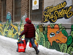 A man leaves the Sun Youth Centre with his Christmas food baskets during the annual christmas basket distribution in Montreal in December 2016.