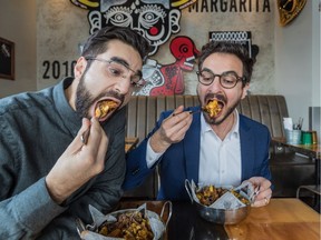 La Poutine Week founders Na’eem Adam, left, and Thierry Rassam chow down at El Gordo, one of more than 50 Montreal restaurants participating in the event's sixth edition, which takes place from Thursday, Feb. 1 to Wednesday, Feb. 7.