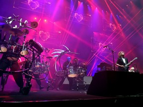 Musician Dave Keuning of The Killers (R) performs with Blue Man Group onstage during the grand opening of T-Mobile Arena on April 6, 2016 in Las Vegas, Nevada.