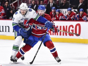 MONTREAL, QC - JANUARY 07:  Nic Dowd #17 of the Vancouver Canucks and Charles Hudon #54 of the Montreal Canadiens skate against each other during the NHL game at the Bell Centre on January 7, 2018 in Montreal, Quebec, Canada.
