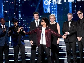 Bruno Mars accepts his Grammy for record of the year for 24K Magic on Sunday, Jan. 28, with members of his production team, including Serban Ghenea, third from left.