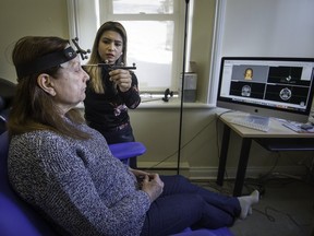 Dr. Rishanthi Sivakumaran creates reference points on the head of Micheline Morency at the Transcranial Magnetic Stimulation laboratory at the McGill research lab in Montreal on Wednesday, Jan. 24, 2018.
