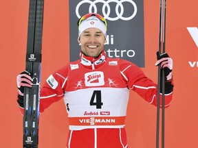 Canada's second placed Alex Harvey celebrates on the podium after the Men's 15 km cross-country World Cup competition in Seefeld, Austria, Sunday, Jan. 28, 2018.