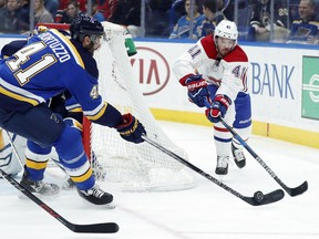 Canadiens' Paul Byron passes the around St. Blues' Robert Bortuzzo Tuesday night.