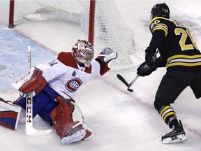 Canadiens goaltender Carey Price reaches back as he tries to make save on a shot by Bruins centre Riley Nash  Wednesday night in Boston.