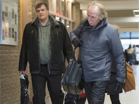 Rail traffic controller Richard Labrie, left, arrives with his lawyer, Guy Poupart, for the third day of jury deliberations on Saturday, Jan. 13, 2018.