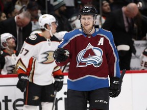 Colorado Avalanche centre Nathan MacKinnon gestures to goaltender Jonathan Bernier after McKinnon scored a goal against the Anaheim Ducks in the second period of an NHL hockey game Monday, Jan. 15, 2018, in Denver.