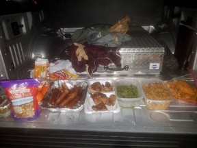 This photo provided by the Jefferson County Sheriff's Office in Beaumont, Texas, shows home-cooked treats taken from federal inmate Joshua Hansen, after he escaped from a federal prison near Beaumont with the intention of breaking back in laden with a duffle bag with bottles of alcohol and home-cooked treats.
