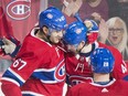 Canadiens' Max Pacioretty (67) celebrates with teammates Paul Byron and Jakub Jerabek (28) after scoring against the Boston Bruins in Montreal on Saturday, Jan. 20, 2018.