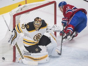Boston Bruins goaltender Tuukka Rask makes a save against Canadiens' Byron Froese in Montreal on Saturday, Jan. 20, 2018.