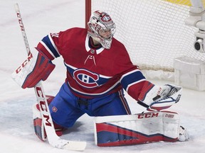 Canadiens goaltender Carey Price makes a glove save against the Vancouver Canucks in Montreal on Sunday, Jan. 7, 2018.