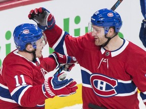 Canadiens' Karl Alzner, right, celebrates with teammate Brendan Gallagher after scoring against the Vancouver Canucks in Montreal on Sunday, Jan. 7, 2018.