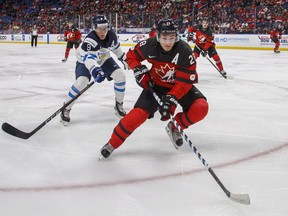 Canada's Victor Mete skates against Finland's Janne Kuokkanen during the second period of IIHF World Junior Championship preliminary round hockey action in Buffalo, N.Y. Tuesday December 26, 2017.