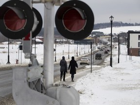 Pedestrians walk along Frontenac St. in Lac-Mégantic on Saturday, Jan. 20, 2018. The strip, which has only one small apartment building that has been rebuilt, was once the heart of the town before a runaway train exploded in the centre of the town on July 6, 2013, killing 47 people.