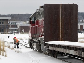 A train conductor switches the tracks as he shunts rail cars on a dry goods train servicing the local building materials industry runs along the Central Maine and Quebec railroad tracks in Lac-Megantic Quebec on Saturday January 20, 2018. A runaway train exploded in the centre of the town on July 6, 2013, killing 47 people.