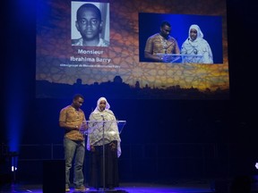 Family members of Mosque shooting victim Ibrahim Barry speak at a gathering at the Pavillon de la Jeunesse, marking the first anniversary of the mosque shooting on Sunday, Jan. 28, 2018, in Quebec City.