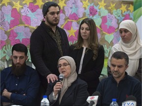 Safia Hamoudi, centre, speaks of the tragedy that took her husband, Khaled Belkacemi, one year after the Quebec City mosque shooting. Hamoudi's son Amir Belkacemi, back left, and her daughter Megda Belkacemi, back centre, stand in support.