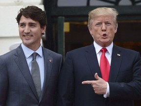 Prime Minister Justin Trudeau is greeted by U.S. President Donald Trump as he arrives at the White House in Washington, D.C., on October 11, 2017. A progressive group says it's baffled that the Canadian government has worked at the NAFTA negotiating table to protect a dispute resolution system that allows companies to sue governments, estimating it has cost Canadian taxpayers $314 million. The Canadian Centre for Policy Alternatives says in a report to be published Tuesday that Chapter 11 provisions in the North American Free Trade Agreement have cost Canada $95 million in unrecoverable legal fees, calculated based on data it obtained through an access to information request.