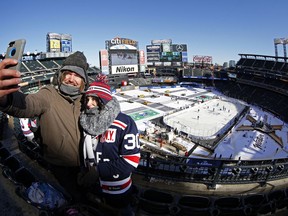 Matt Gagas takes a selfie with Jennifer DeVito before the Buffalo Sabres take on the New York Rangers in the NHL Winter Classic hockey game at CitiField in New York on Monday, Jan. 1, 2018.