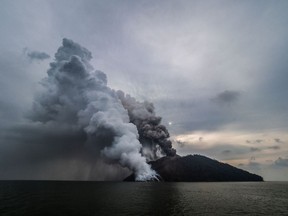 In this photo provided by Brenton-James Glover, ash plumes rise from the volcano on Kadovar Island, Papua New Guinea in the South Pacific Sunday, Jan. 21, 2018. The island volcano erupted again Sunday, sending plumes of steam and ash into the air.