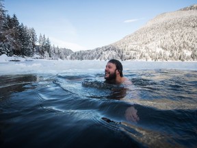 Allan Gossen swims in Kawkawa Lake during a polar bear dip in Hope, B.C., on Monday, January 1, 2018.