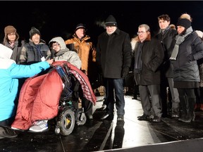 Aymen Derbali, a victim who was shot seven times, front left to right, speaks during a vigil to commemorate the one-year anniversary of the Quebec City mosque shooting as Quebec Premier Philippe Couillard, Quebec City Mayor Regis Labeaume, Prime Minister Justin Trudeau and Montreal Mayor Valerie Plante look on, in Quebec City, Monday, Jan. 29, 2018.
