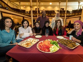 Tahay Okby, Sondos Nasassra, Intesar Sakran, Aruba Karim, Neda Samaha and Amal Elsana, sitting, left to right, and Anwar Alhjooj and Fatima Al Anati, standing left to right, helped out at the Benefit for Camp Cosmos at St. James United Church in Montreal Dec. 10, 2017.