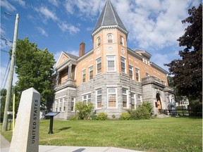 The Haskell free library and a sidestreet with border marker that marks the line seperating Canada and USA, in Stanstead.