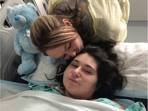 The sister of a young Quebec woman who had her limbs amputated after being electrocuted when her car struck an electrical pole in western Quebec has set up a fundraising campaign. Samantha Mongeon, left, kisses her sister Sabryna in this undated handout photo.