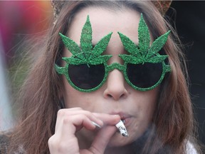 A woman smokes marijuana on Parliament Hill, April 20, 2017.