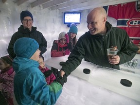 Derek Parker greets young fans during his Habs game party in his backyard ice palace/bar in Brossard on Thursday, Feb. 1, 2018.