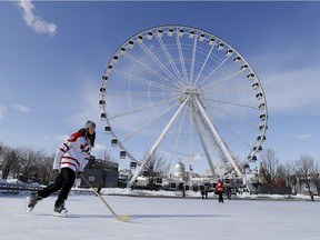 Former Team Canada hockey player Charline Labonte skates with the golden hockey stick as part of an Olympic fan event in Montreal on Friday February 2, 2018. (Allen McInnis / MONTREAL GAZETTE)