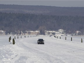 A motorist crosses the seasonal ice bridge from Oka to Hudson last Thursday.