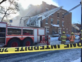 Montreal firefighters battle a blaze near the intersection of Pierre-de-Coubertin St. and Pie IX Blvd. Thursday, Feb. 8, 2018.